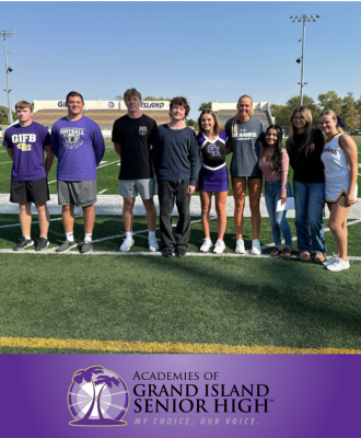  Group photo of homecoming court on the football field at a pep rally.